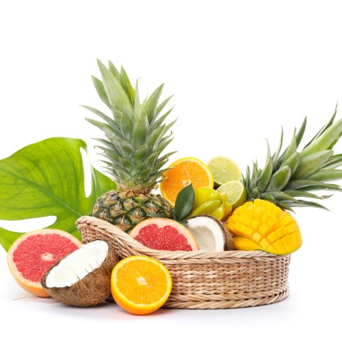 Wicker basket with fresh exotic fruits isolated on white background